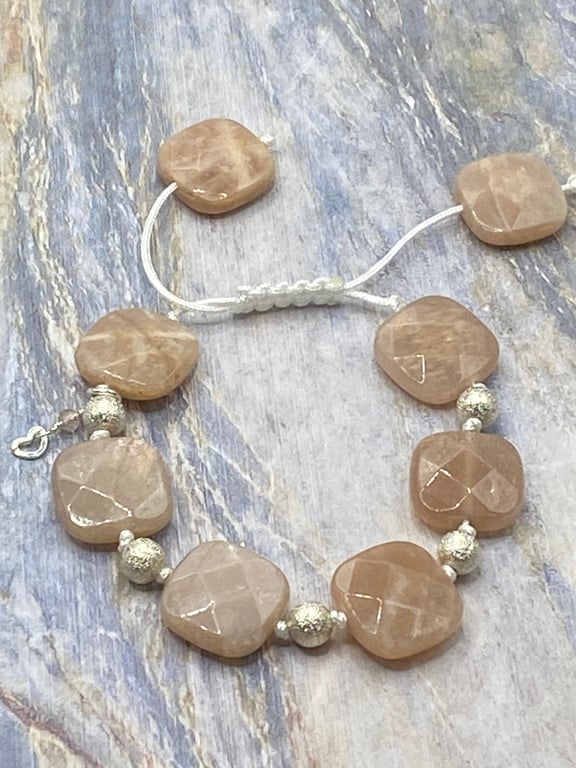 Knotted macrame cord bracelet with peach sunstone squares