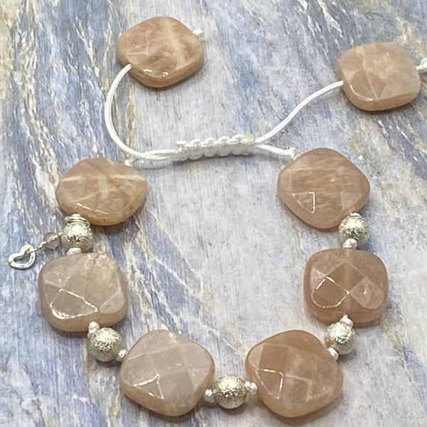 Knotted macrame cord bracelet with peach sunstone squares