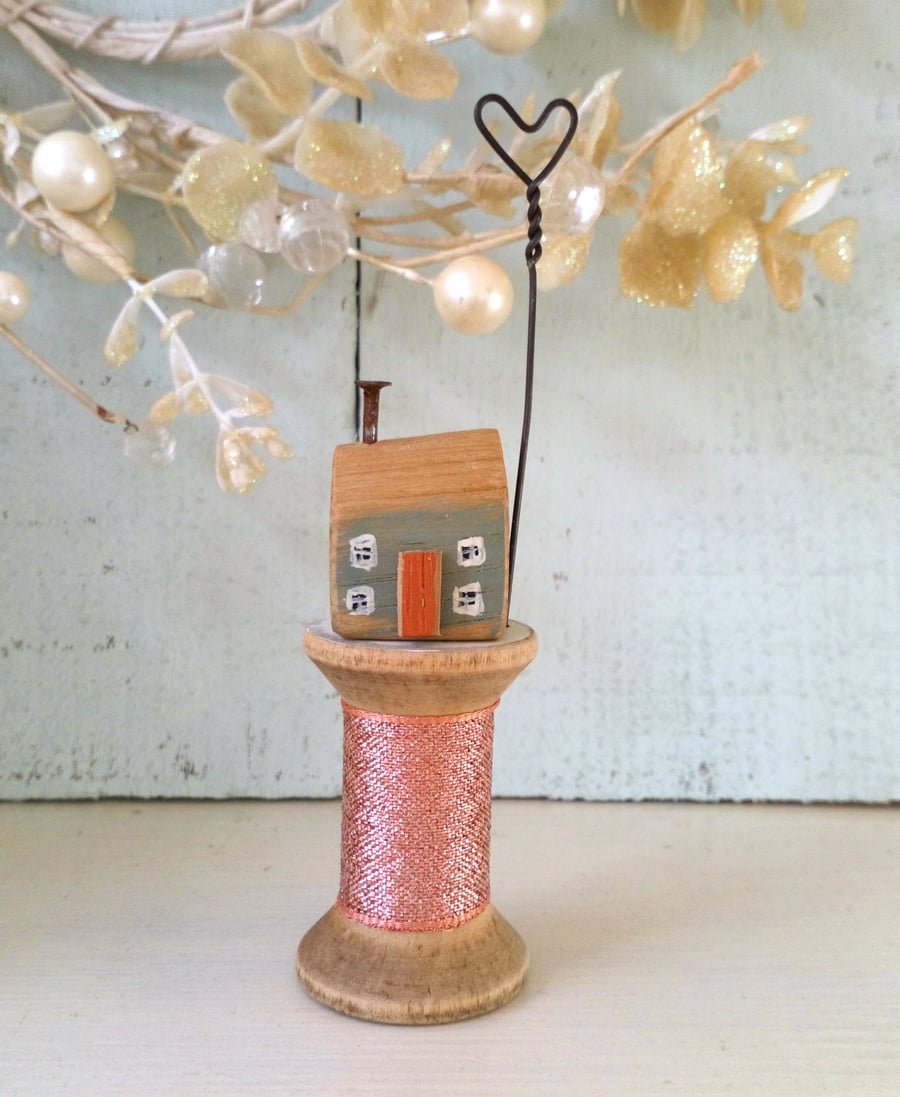 Little wooden house with wire heart on vintage bobbin