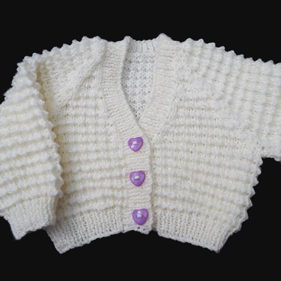 Hand knitted baby cardigan in cream with textured pattern 