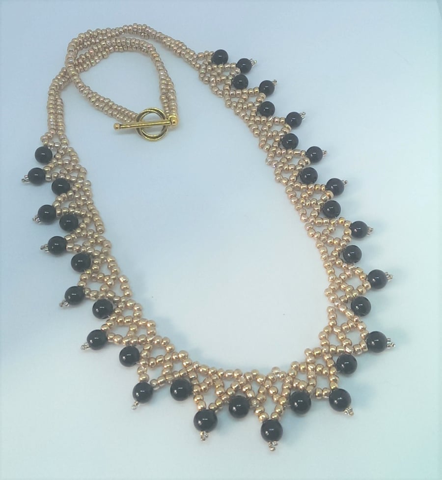 Pretty gold and black beaded statement necklace