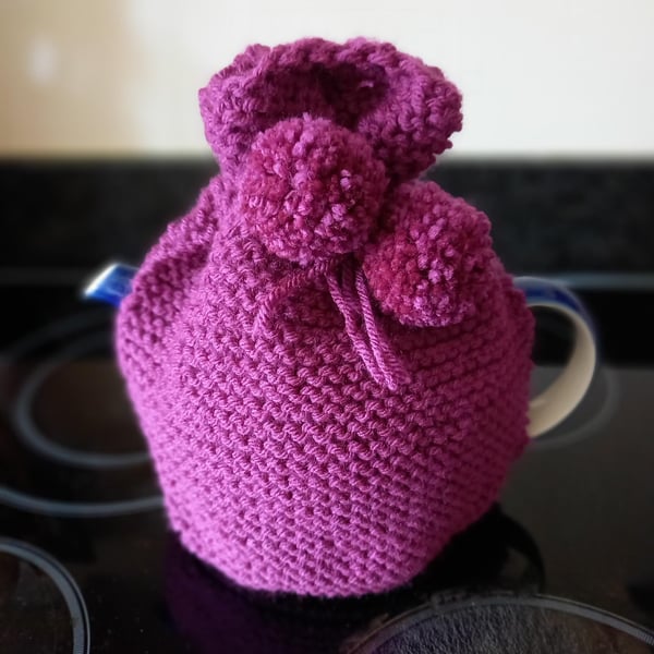 Hand knitted 2 pint (4 cup) tea cosy in Plum with matching Pom poms