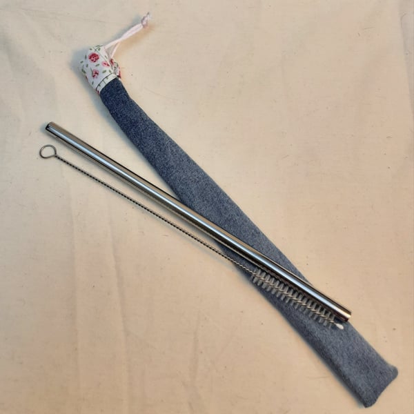 Reusable metal straw and cleaning brush with denim cover.