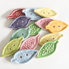 Set of handmade ceramic leaf shaped buttons