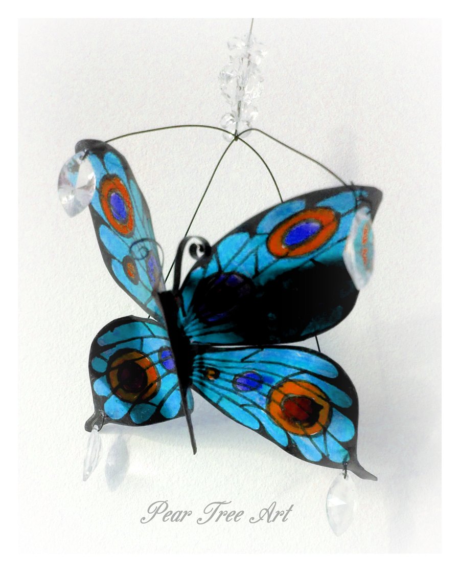 Turquoise metal butterfly hanging decoration made from a coffee tin.