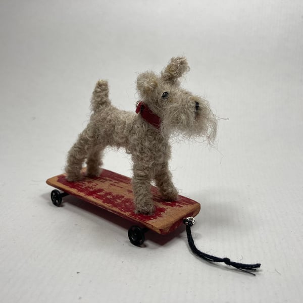 Scoot - miniature terrier on a wooden trolley. 