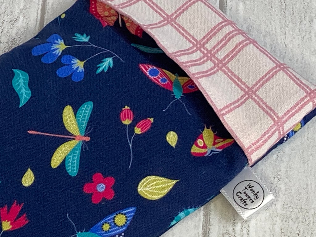 Reusable snack bag with food-safe lining. Navy flowers and insects.