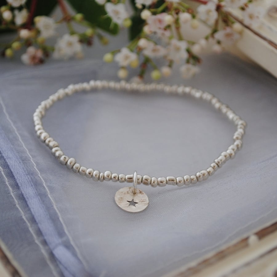Silver charm and bead stretch bracelet