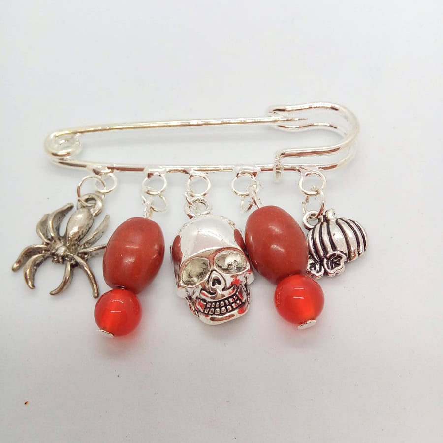 Brooch with a Spider Skull and Pumpkin Charms and Beaded Charms