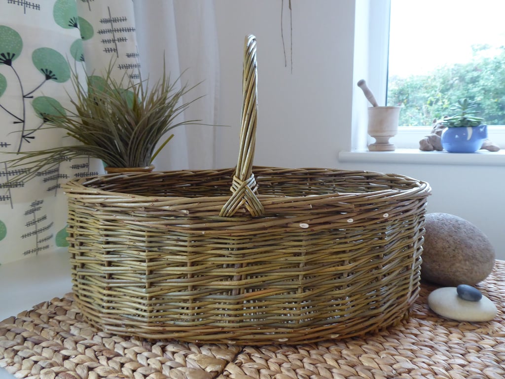 A Handmade Oval Willow Basket with a Catalan Style Base.