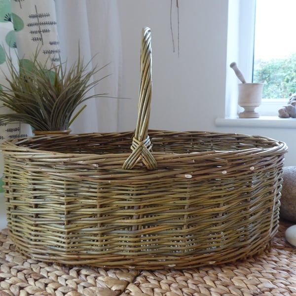 A Handmade Oval Willow Basket with a Catalan Style Base.