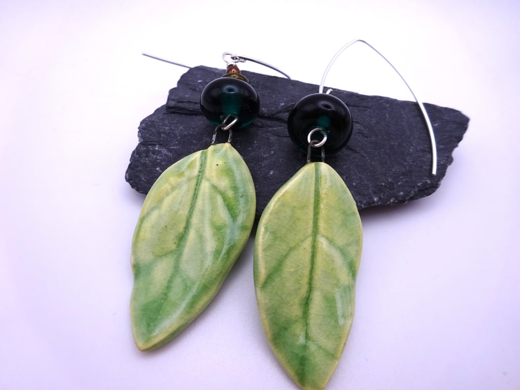 green lampwork glass earrings, ceramic leaf