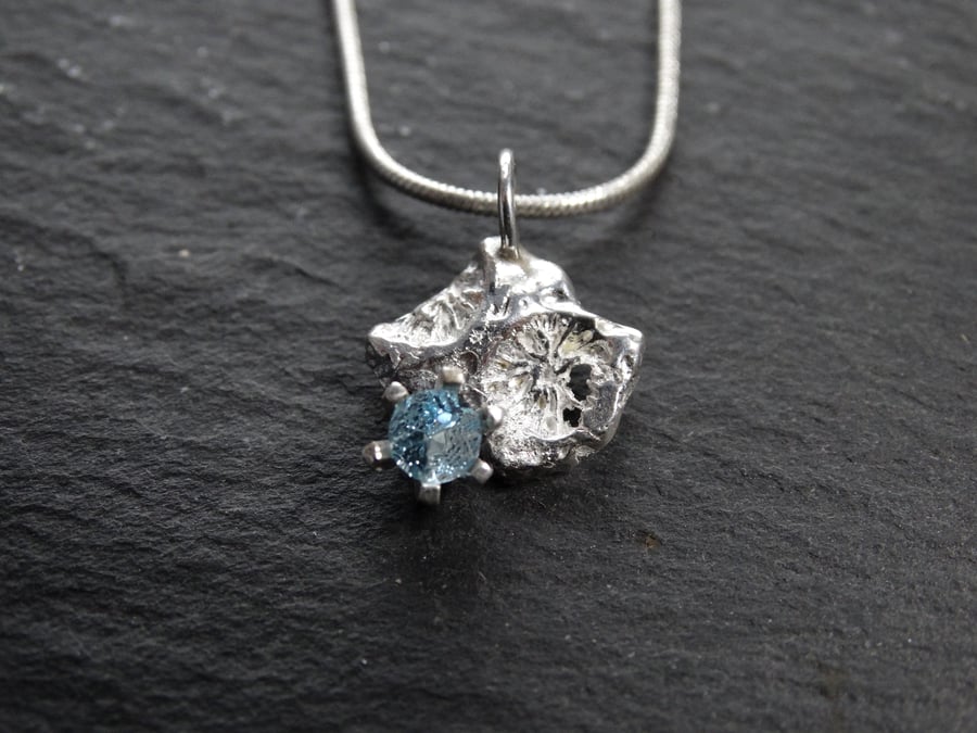 Sterling silver cast coral chip set with blue topaz