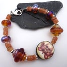 lampwork glass, ceramic moth skull and sunstone gemstone bracelet