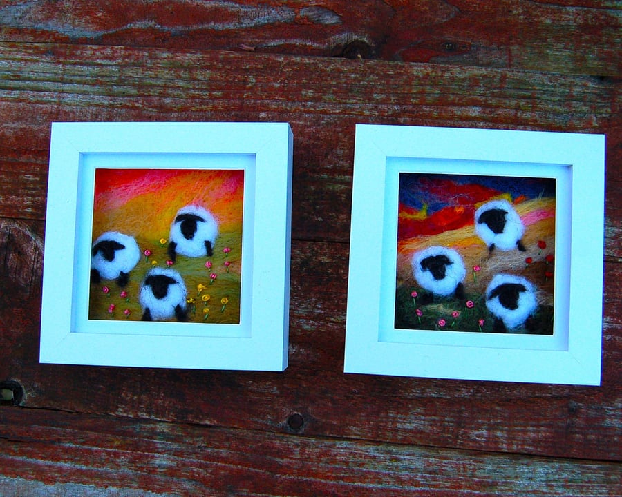 Colourful sheep wool painting.  Needlefelt picture of three sheep and flowers