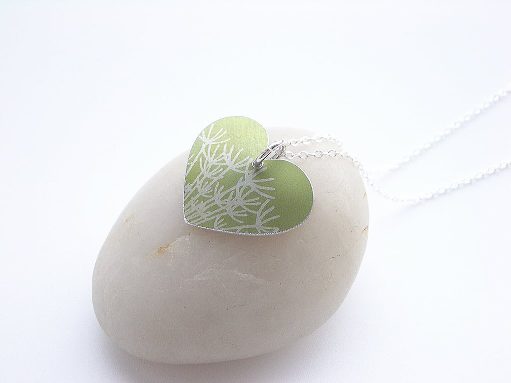 Green heart pendant necklace with dandelion seeds
