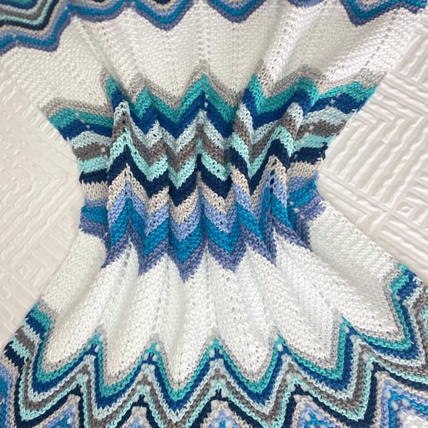 Shades of blue grey and aqua baby blanket, hand knitted in cotton yarn.