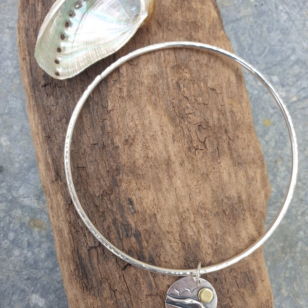 Sterling silver textured bangle with coastal scene charm