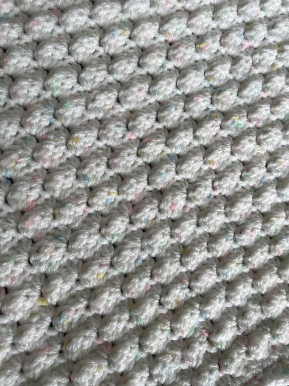 Hand Crochet Baby Blanket in White with pastel coloured highlights