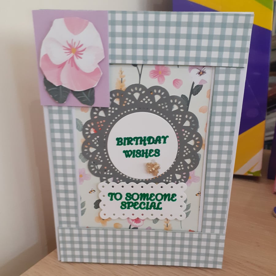 Birthday greetings card flower with green and white checked border 