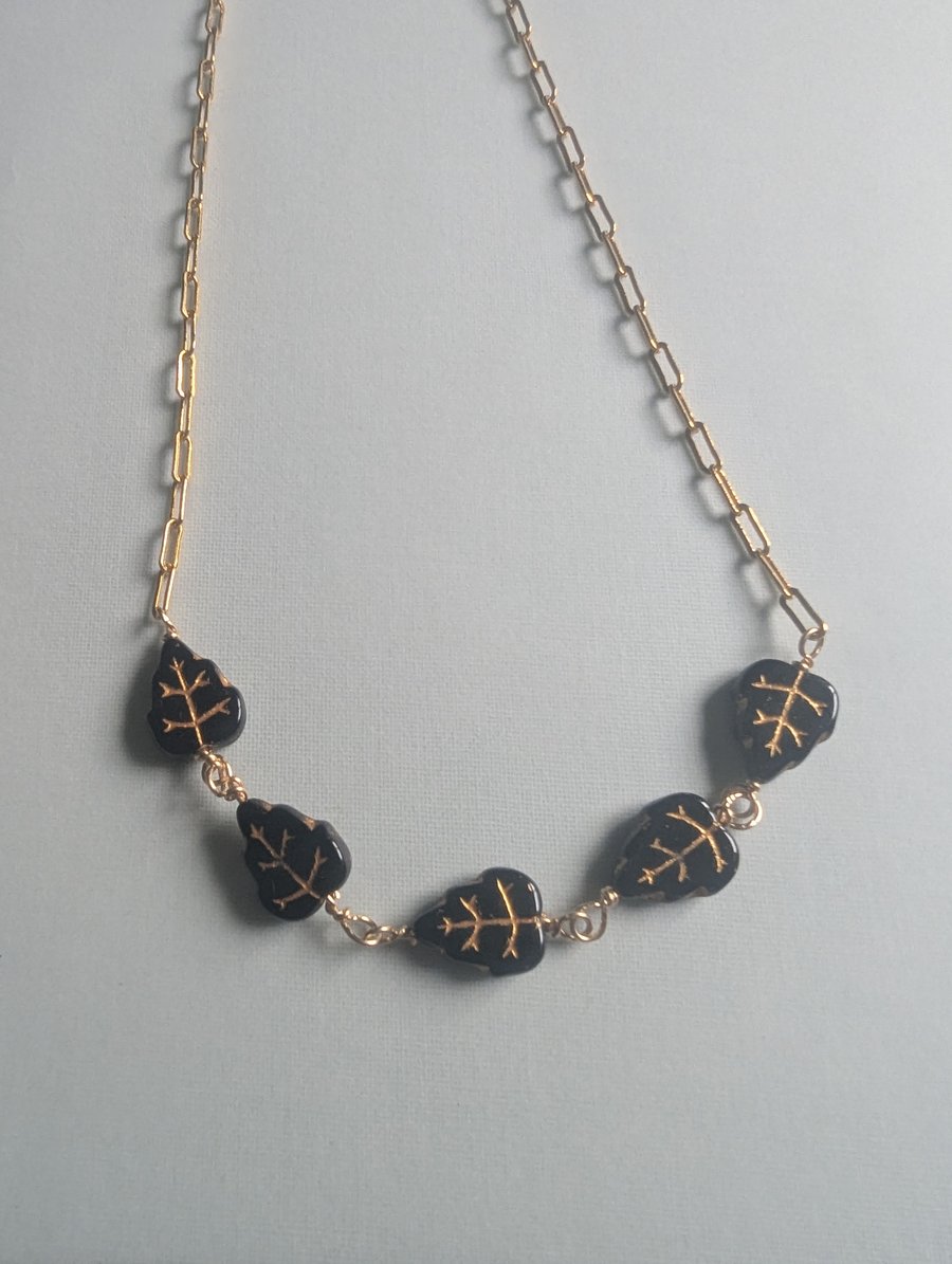 Gold filled chain necklace with black and gold Czech glass  leaf beads