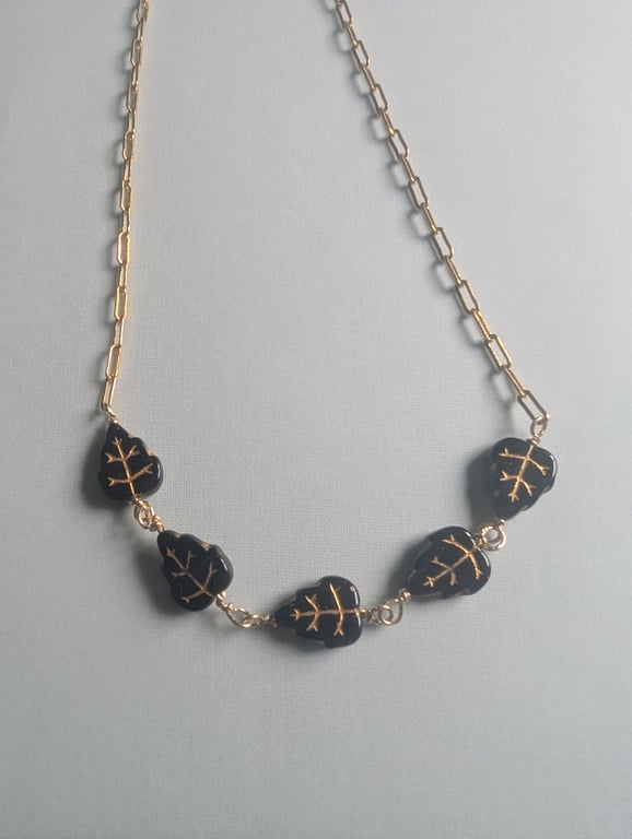 Gold filled chain necklace with black and gold Czech glass  leaf beads