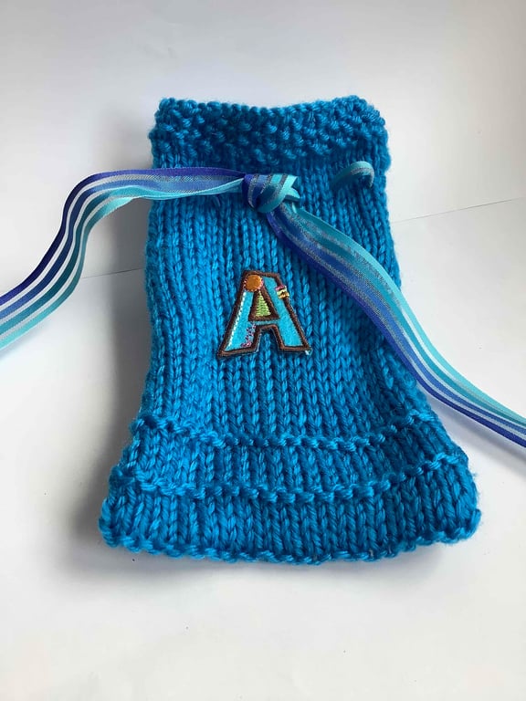 Initialled  A blue knitted gift bag