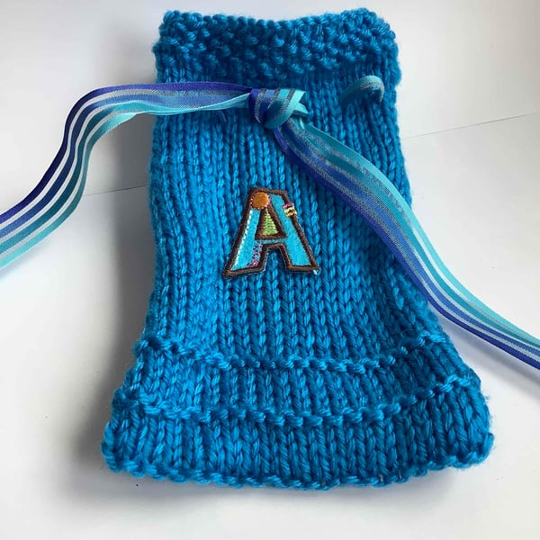 Initialled  A blue knitted gift bag
