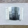 Unframed handwoven tapestry weaving, textile art in black, grey and cream