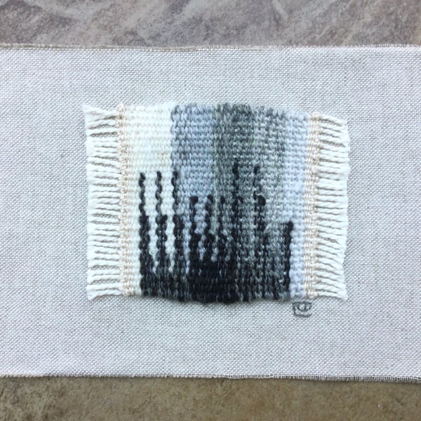Unframed handwoven tapestry weaving, textile art in black, grey and cream