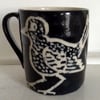 Black stoneware mug with bird decoration