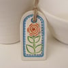 Small ceramic gift tag decoration with flower