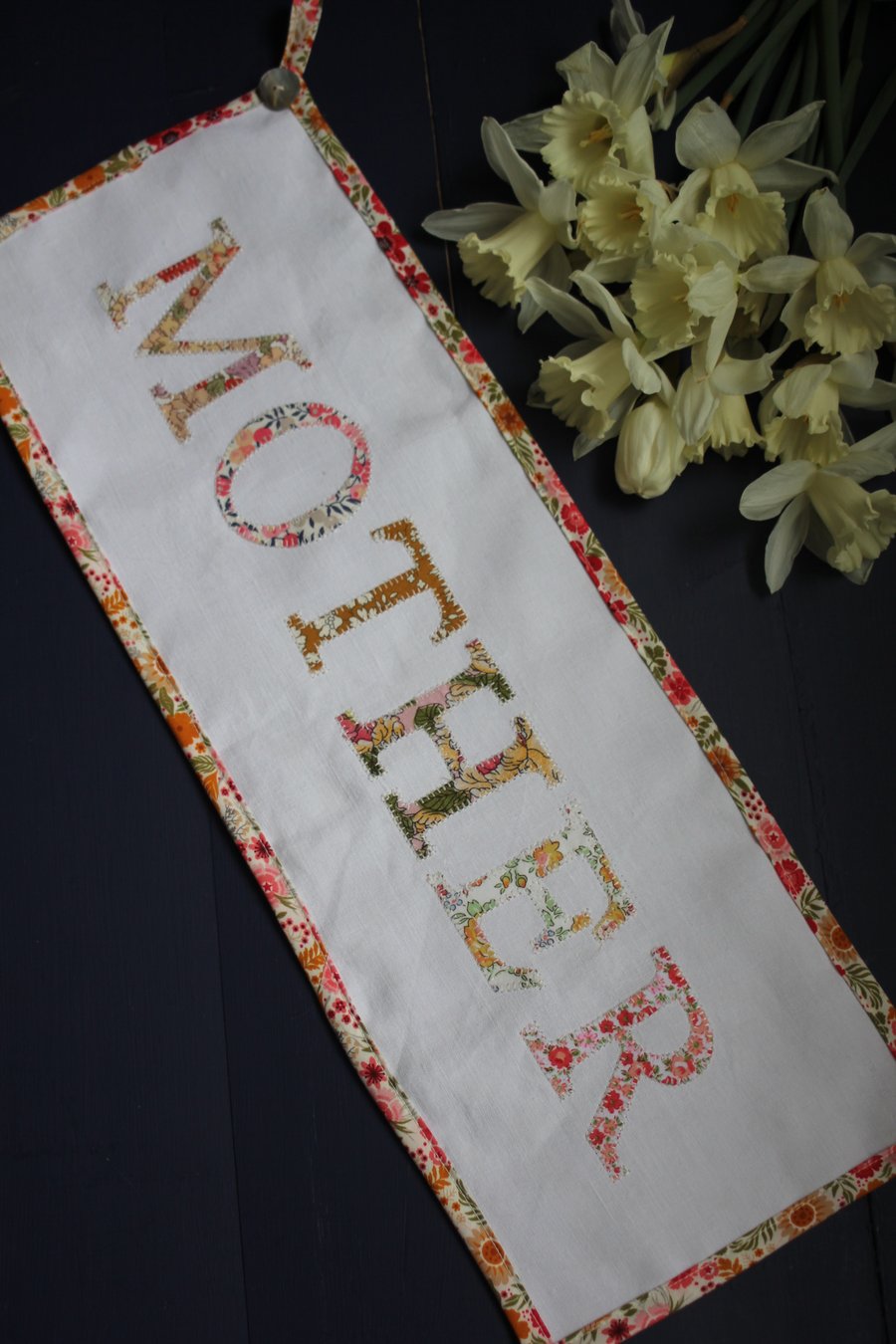 Floral 'Mother' fabric banner in shades of peach, pink and yellow