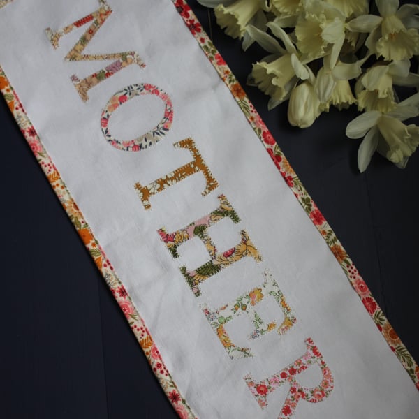 Floral 'Mother' fabric banner in shades of peach, pink and yellow