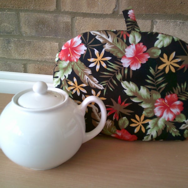 Small Tea Cosy with Red Hibiscus Flowers on a Black Background
