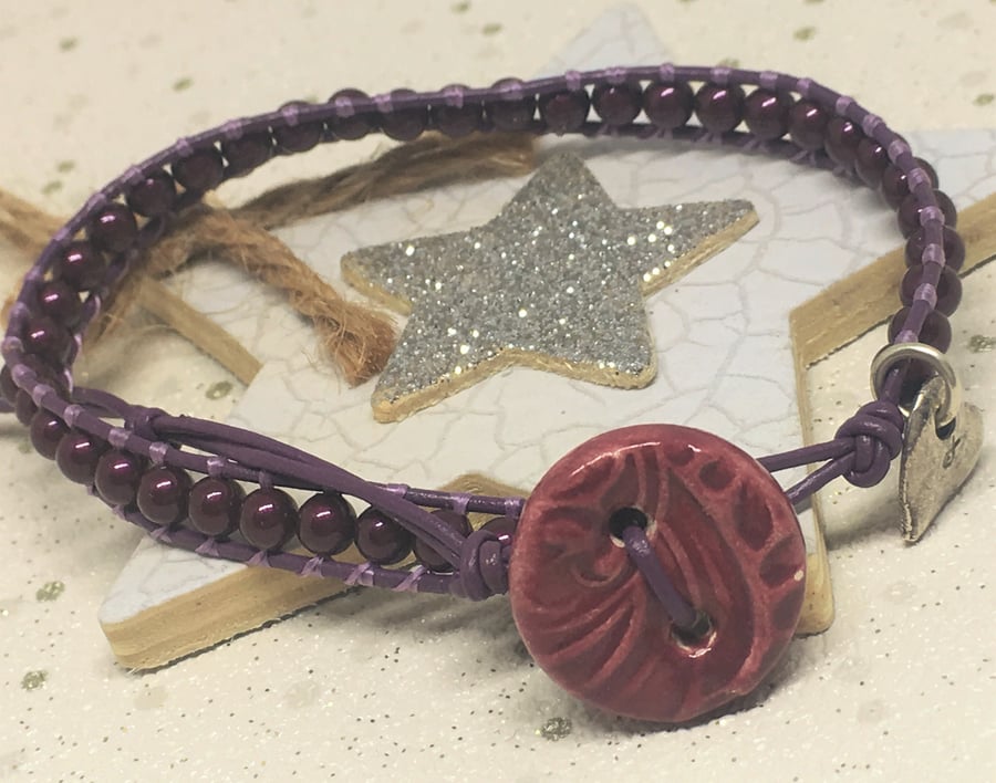 Purple leather and glass pearl bracelet with ceramic button