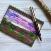 Embroidered sunset landscape A6 recycled lined notebook.