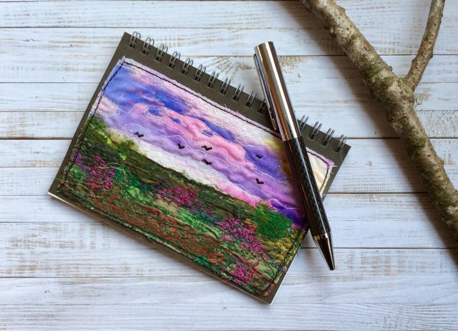 Embroidered sunset landscape A6 recycled lined notebook.