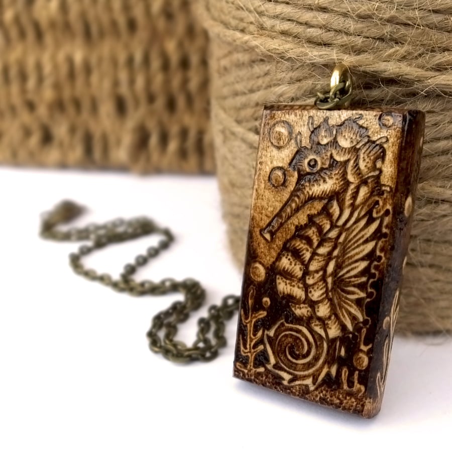 Seahorse in the deep ocean. Chunky pyrography sycamore wooden pendant.
