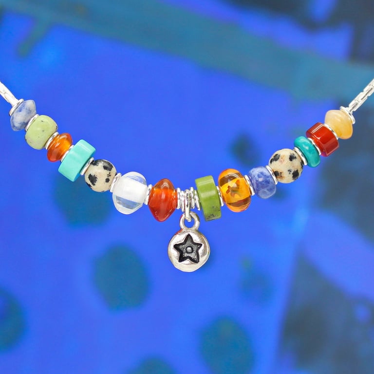 Star necklace pendant with multi-coloured gemstones on a sterling silver chain. 
