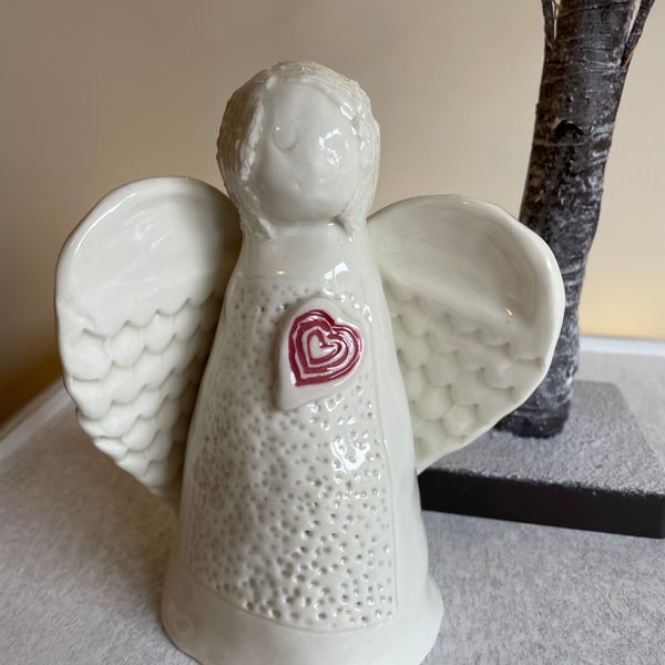 Celestial porcelain angel with red heart detail