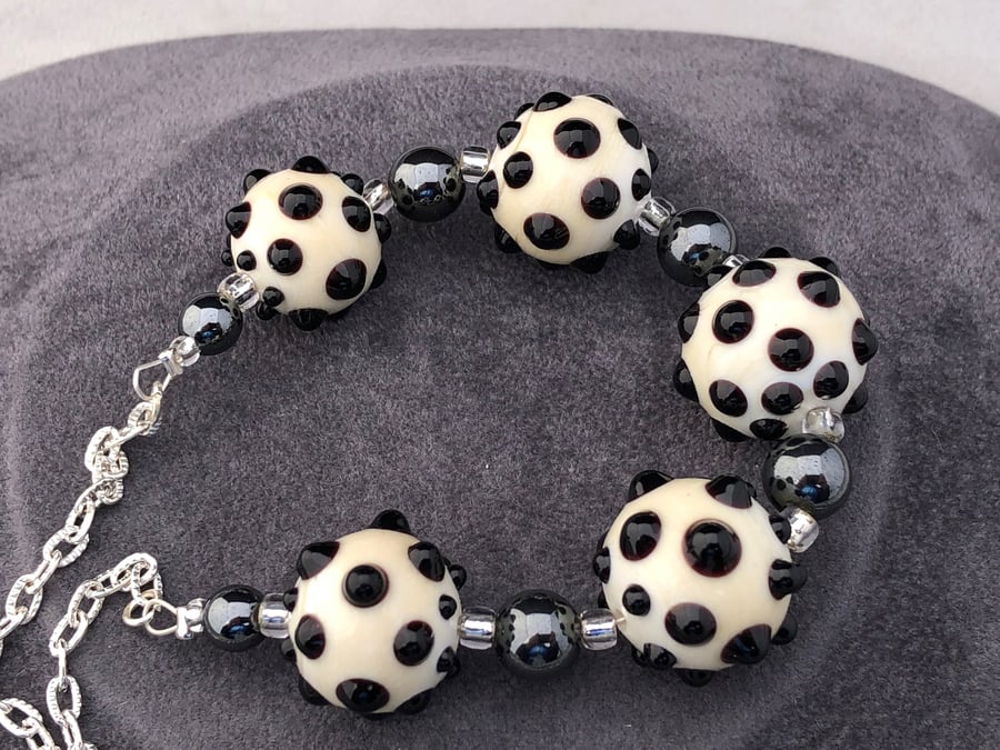 cream ivory and black lampwork glass beaded necklace with haematite stones