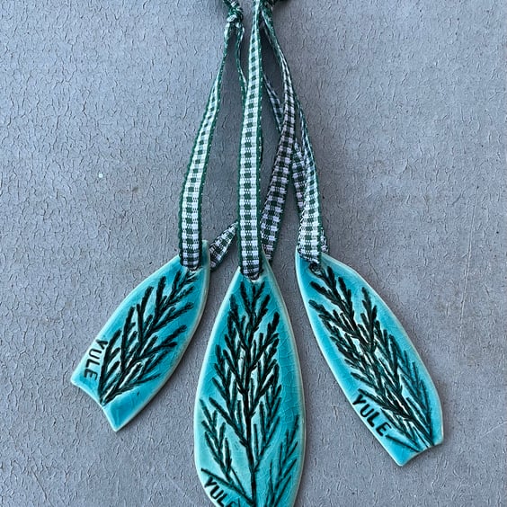 Set of three ceramic Yule decorations .