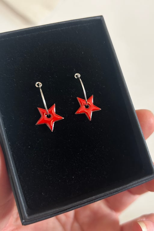 Enamel star earrings on silver hoops