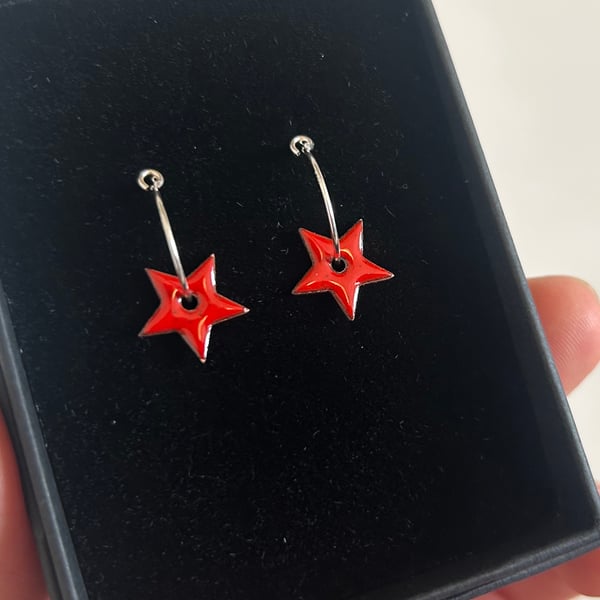 Enamel star earrings on silver hoops