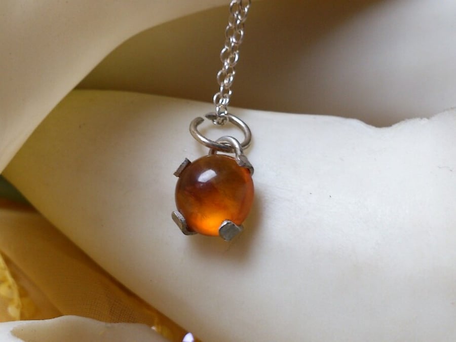 Amber and sterling silver claw necklace