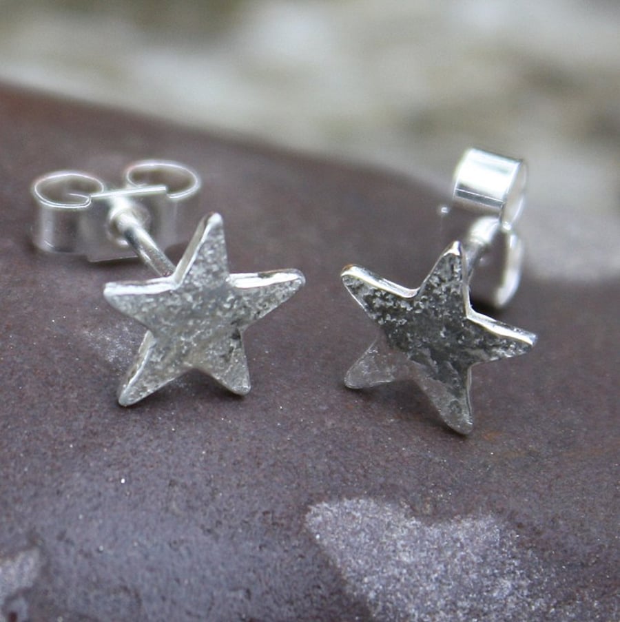 Tiny silver star stud earrings.
