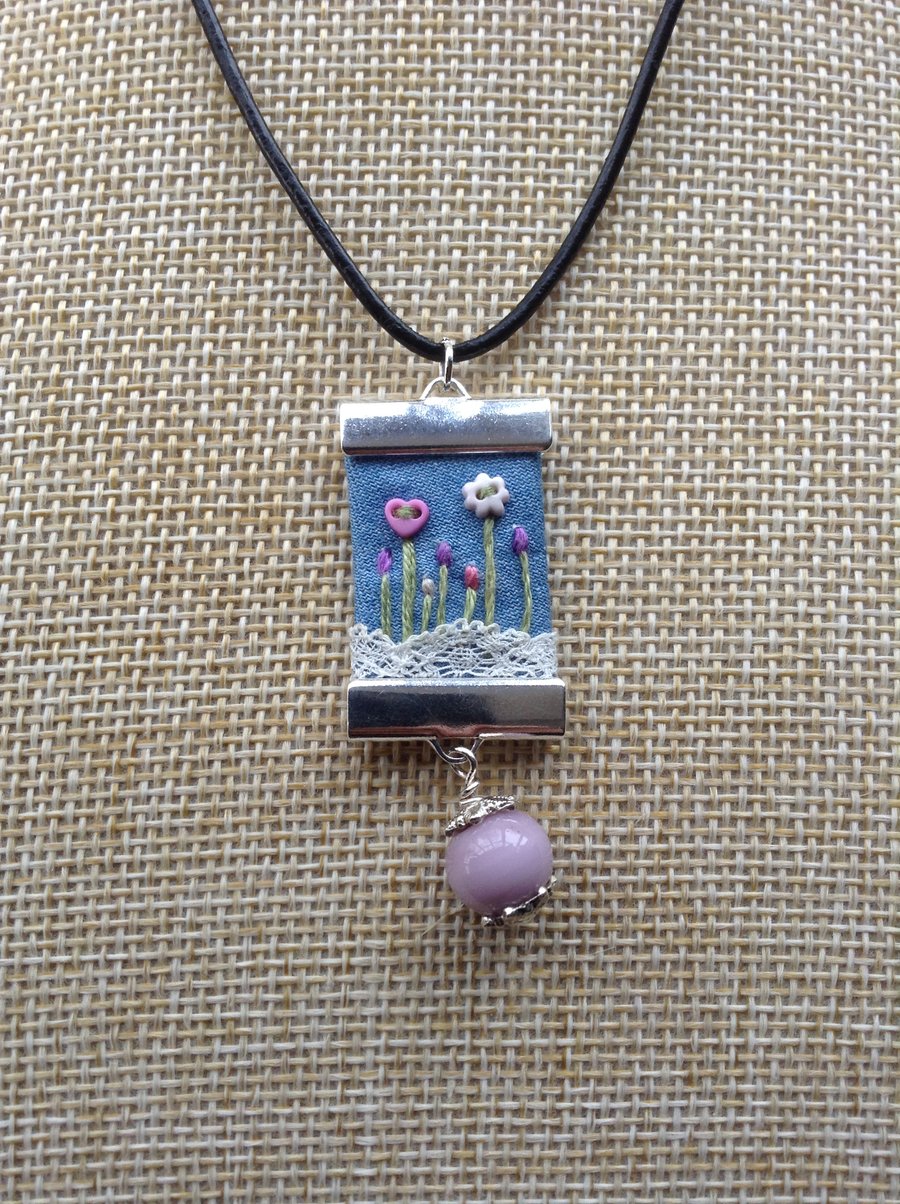 Denim and lace pendant necklace.