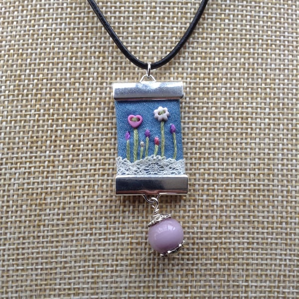 Denim and lace pendant necklace.