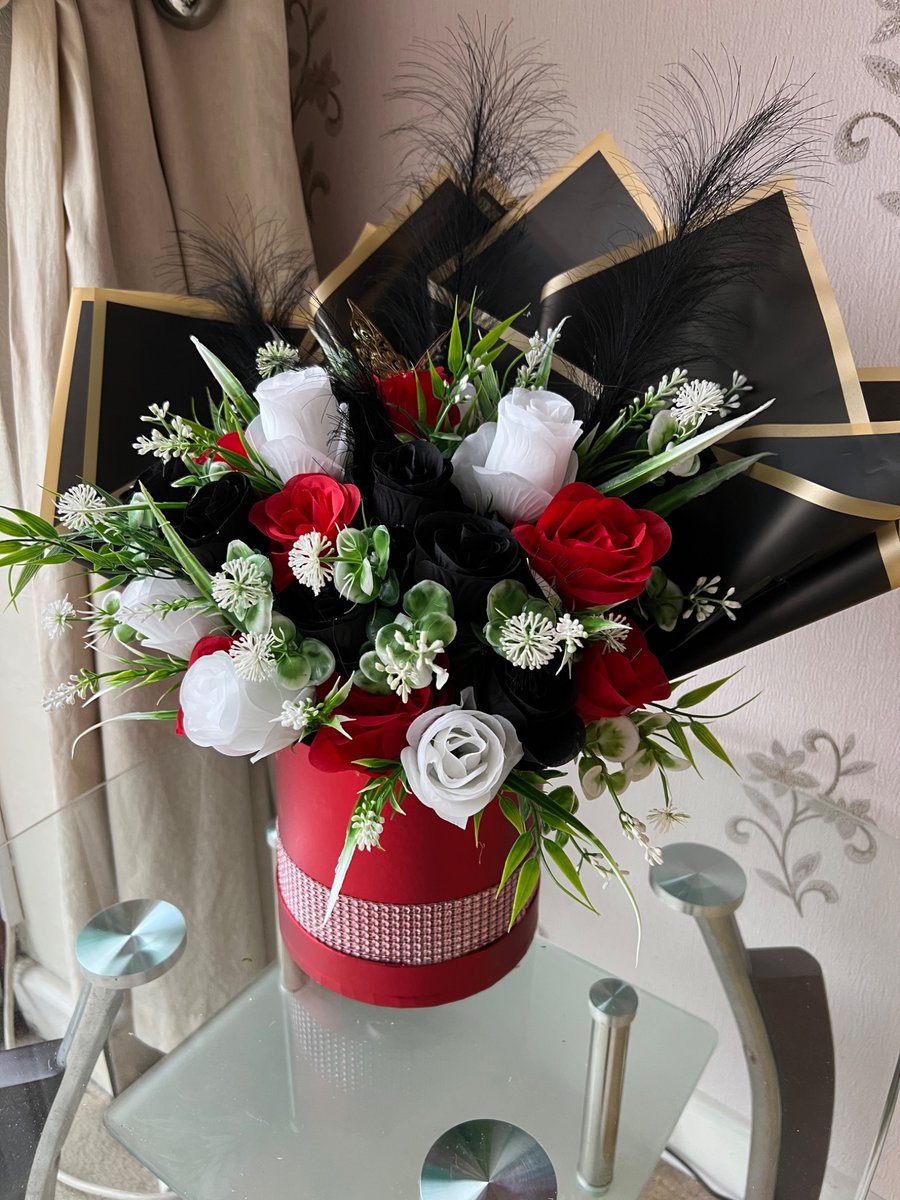 Red hatbox with red, white and black roses